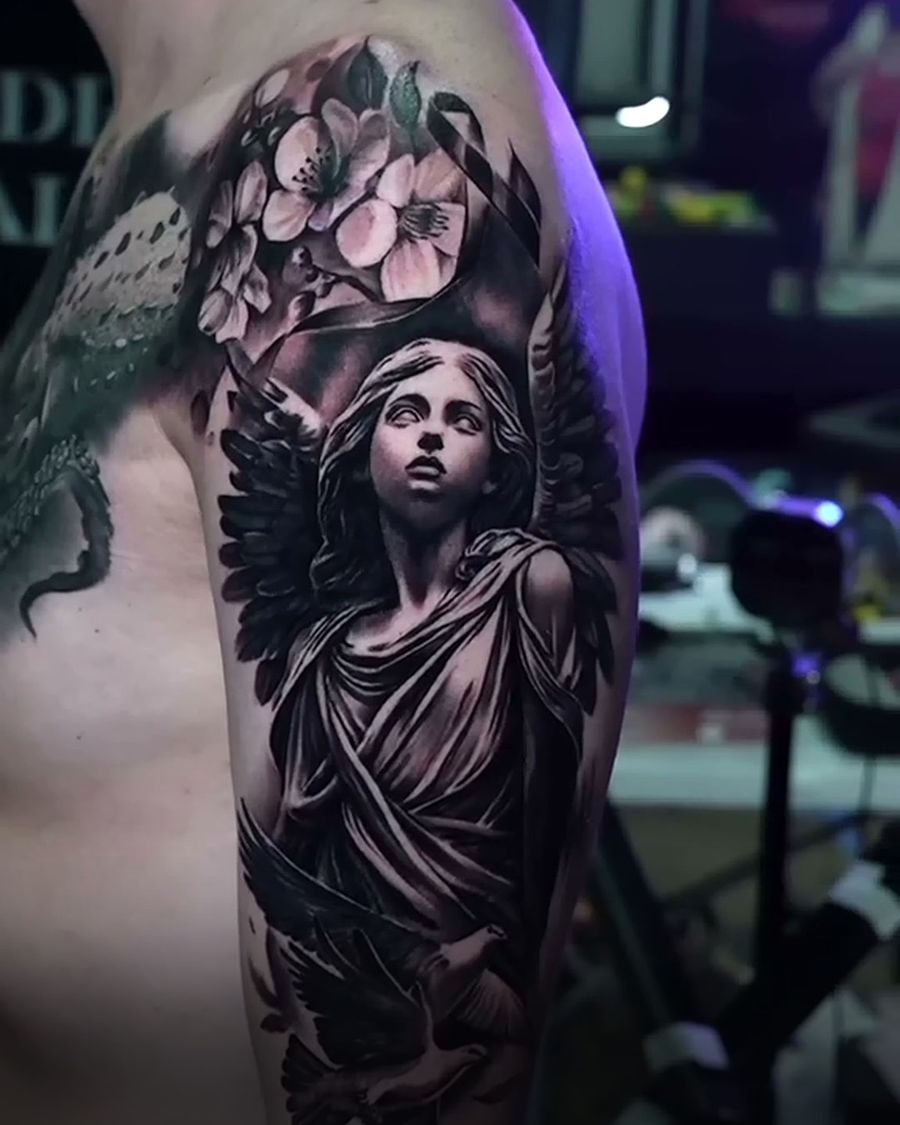Healed black and grey angel statue arm tattoo