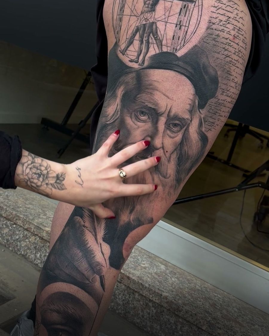Healed Leonardo da Vinci black and grey leg tattoo