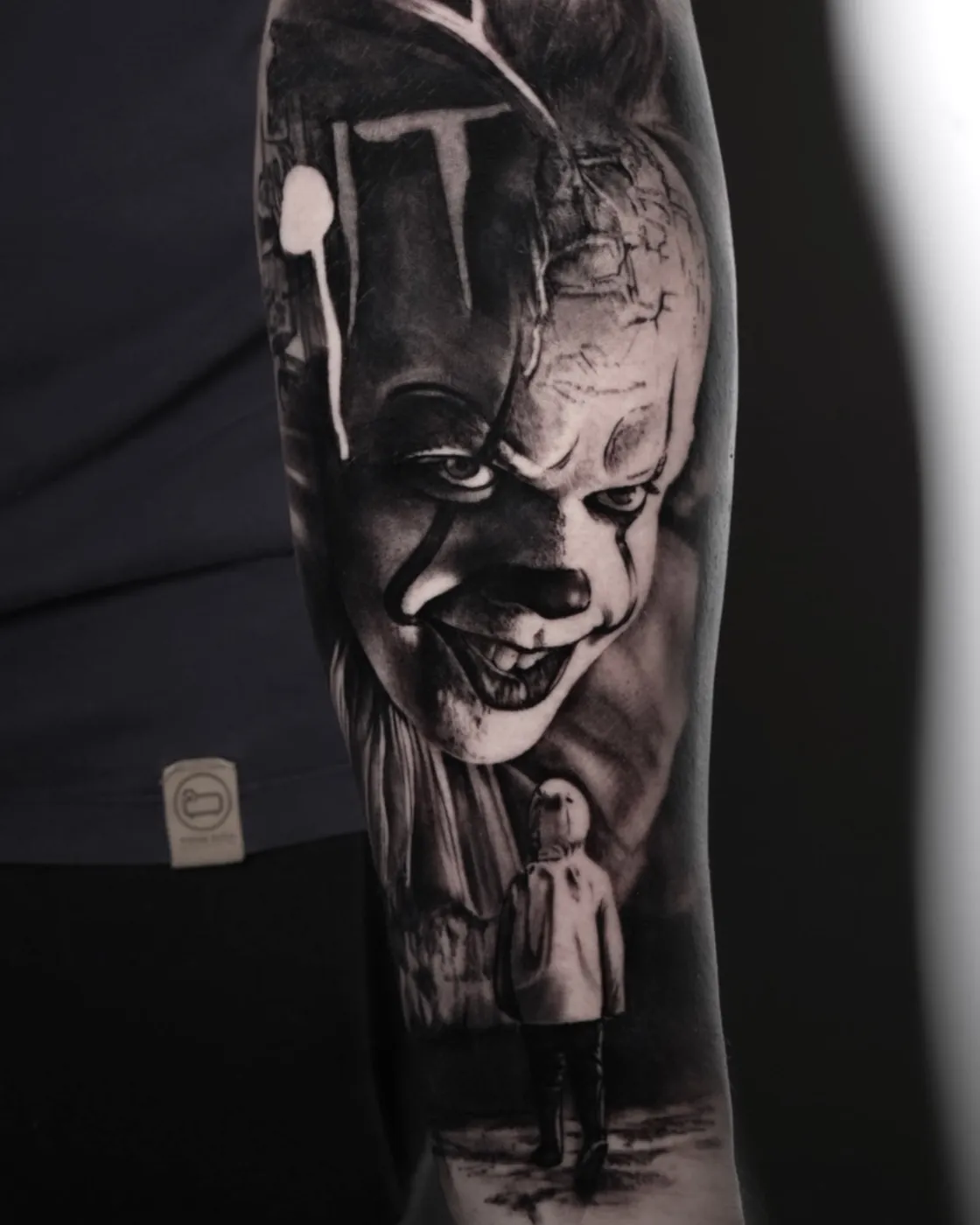 Black and grey horror character portrait forearm tattoo