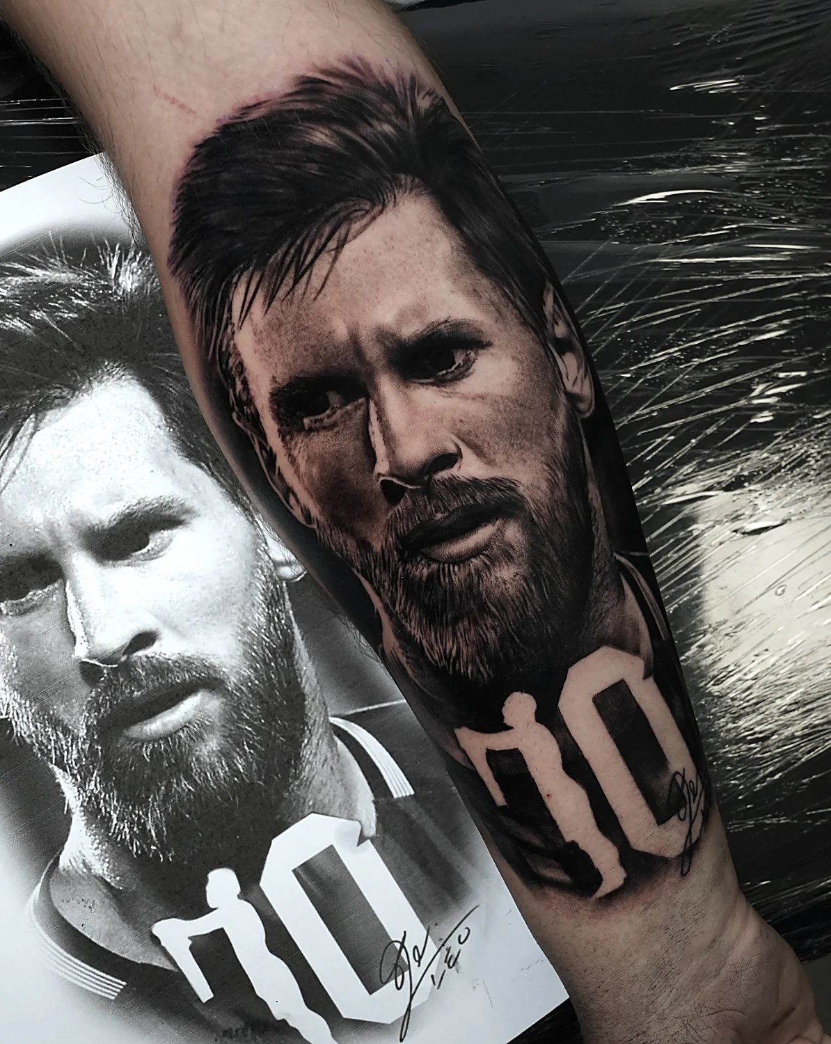 Black and grey footballer portraits tattoo