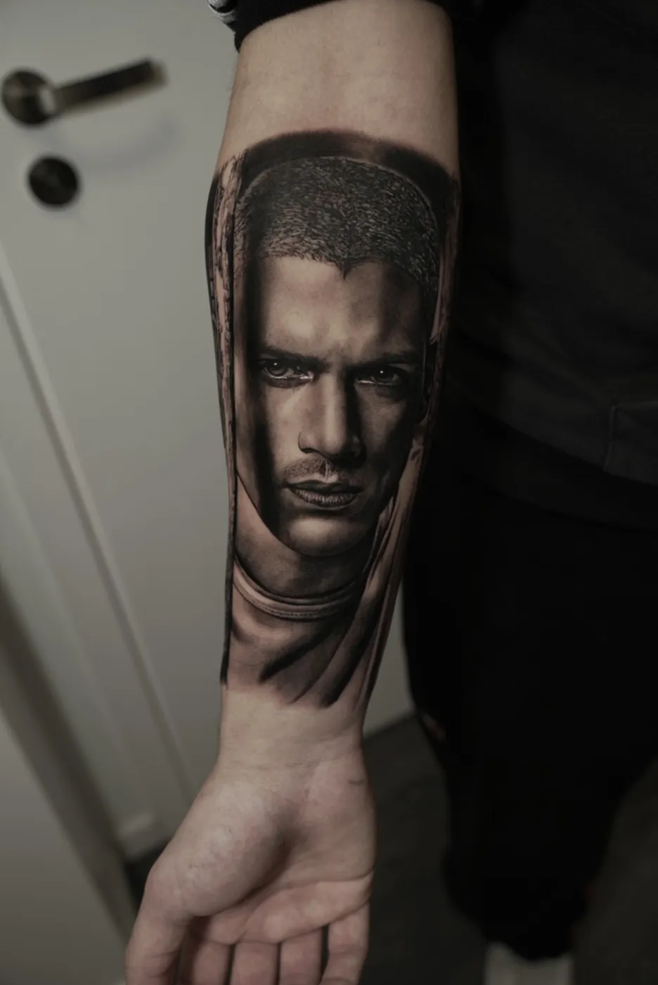 Black and grey David statue forearm tattoo